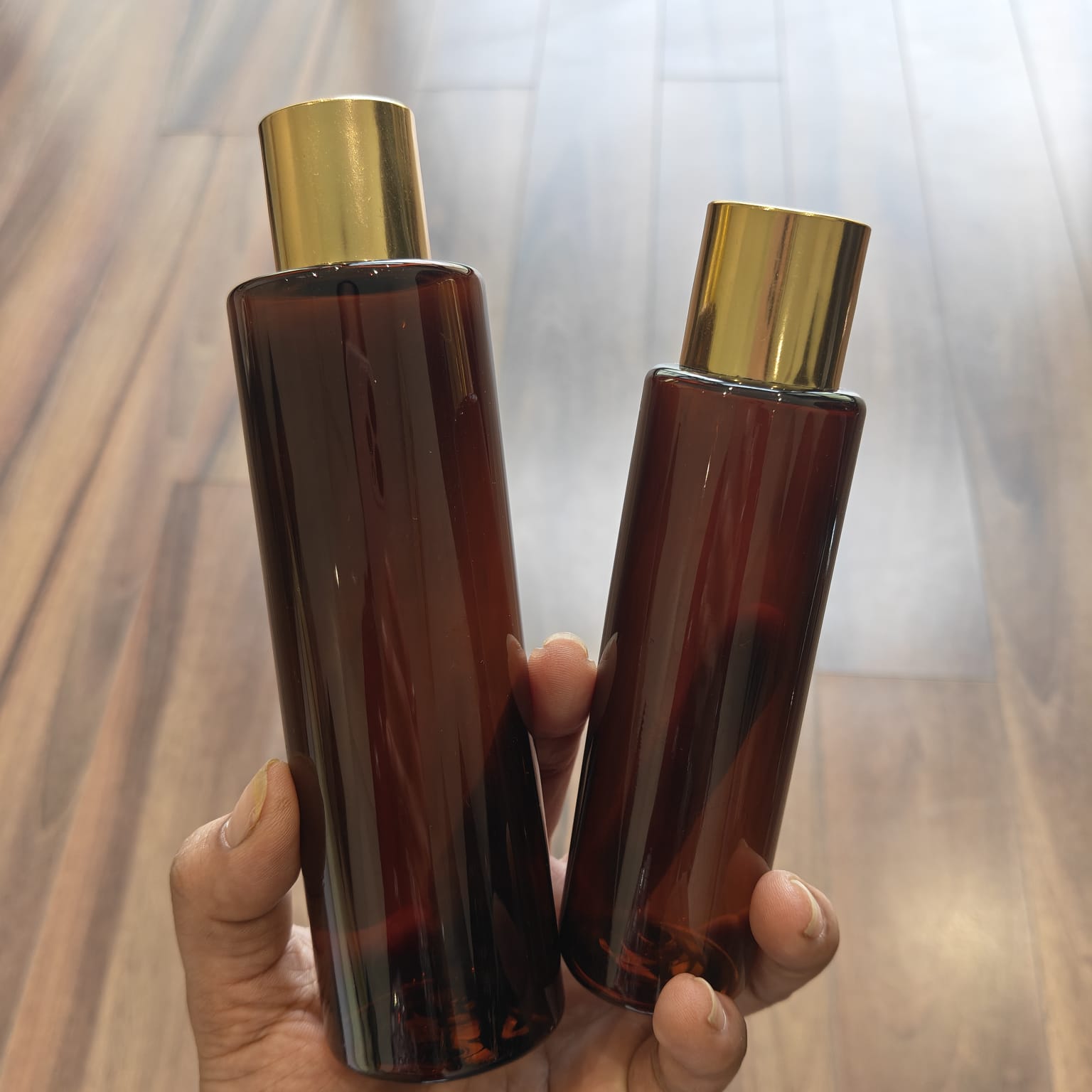 100ml–200ml Sleek Cylinder Amber Bottle with Gold Screw Cap | Cosmetic Packaging