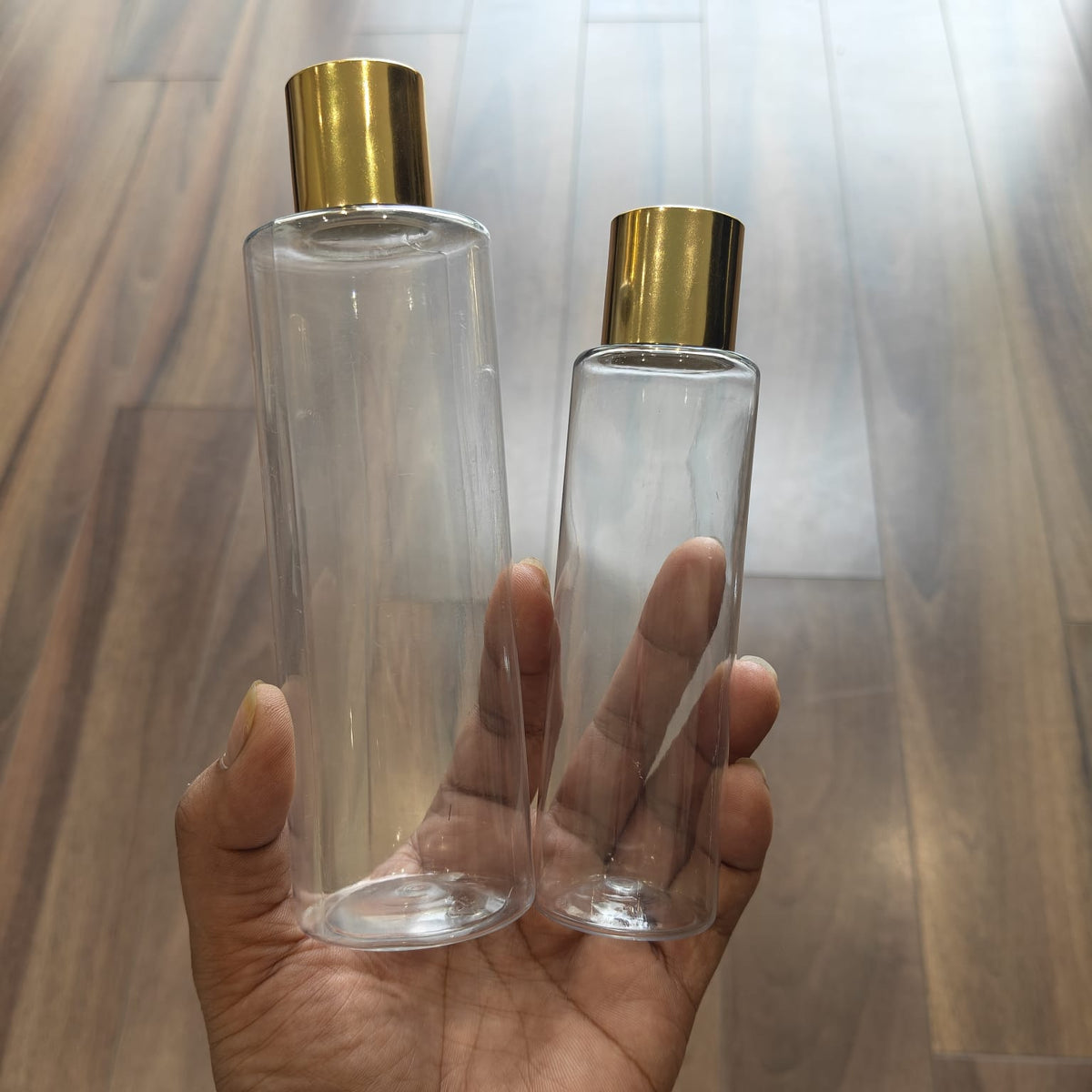 100ml–200ml Sleek Cylinder Clear Bottle with Gold Screw Cap | Cosmetic Packaging