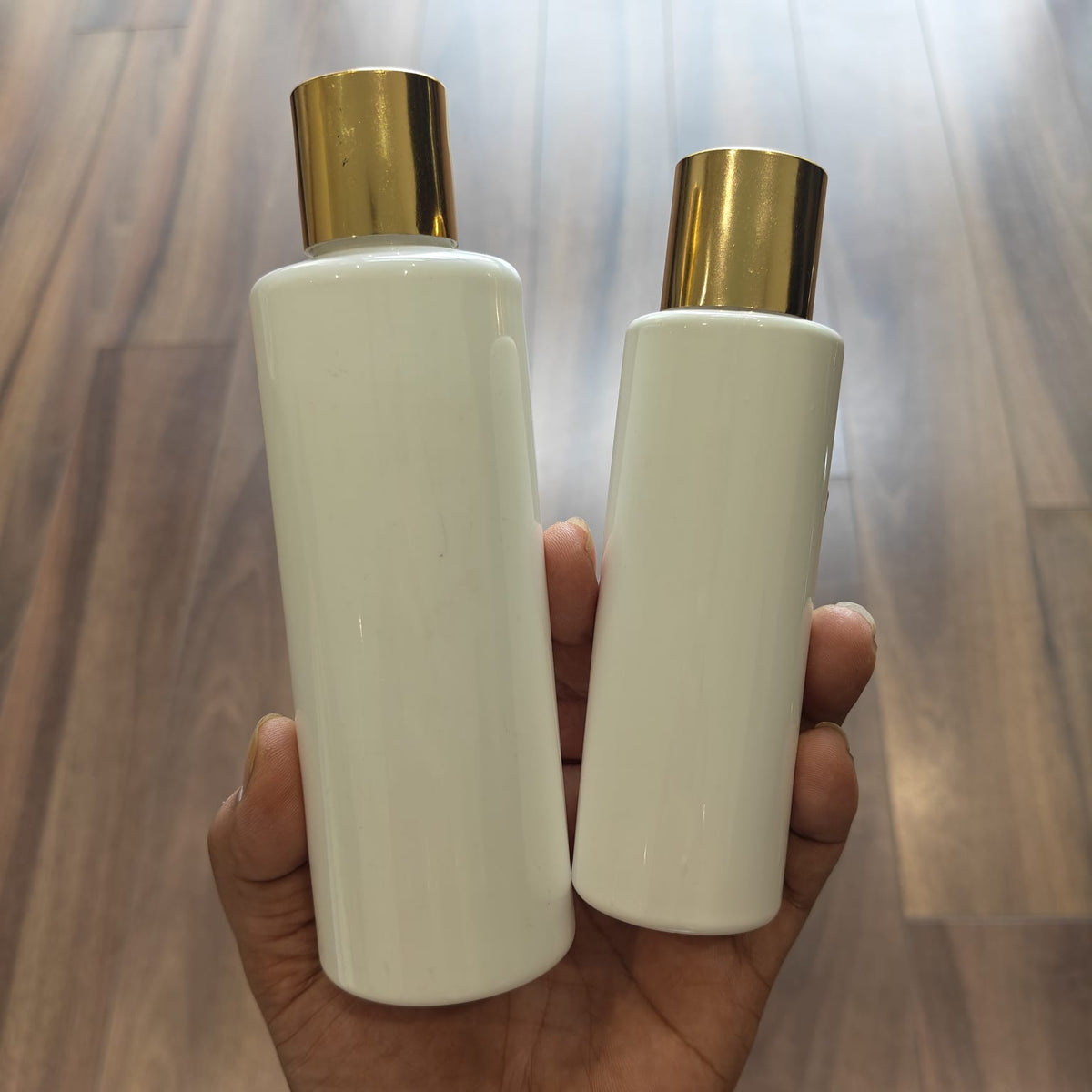 100ml–200ml Sleek Cylinder White Bottle with Gold Screw Cap | Cosmetic Packaging